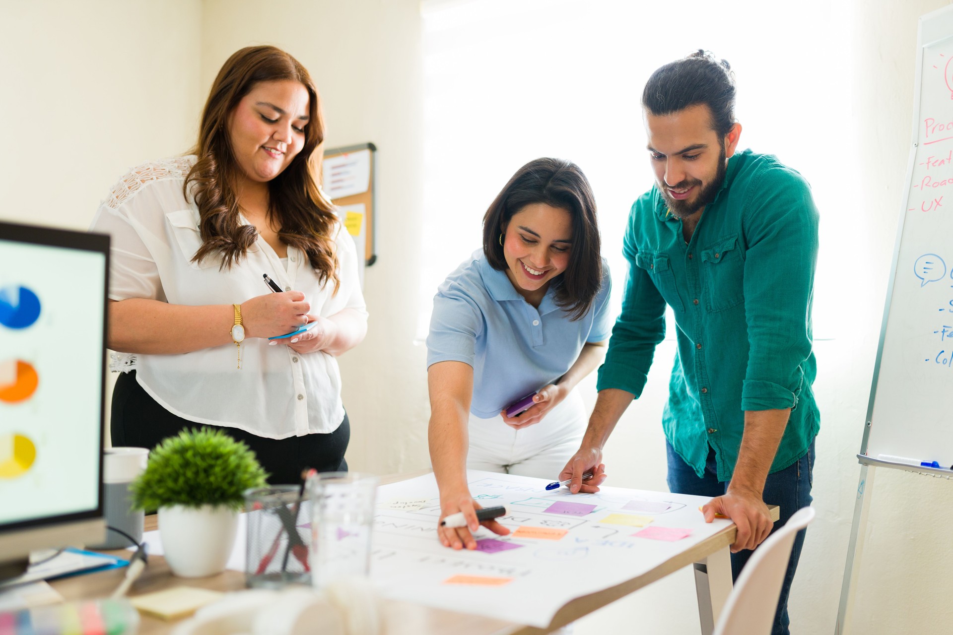 Business team brainstorming and planning using sticky notes in office